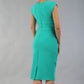 model wearing diva catwalk daphne sleeveless pencil dress with rounded neckline with split in the middle in Emerald Green back