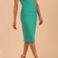 model wearing diva catwalk daphne sleeveless burn orange pencil dress with rounded neckline with split in the middle in front in Emerald Green front