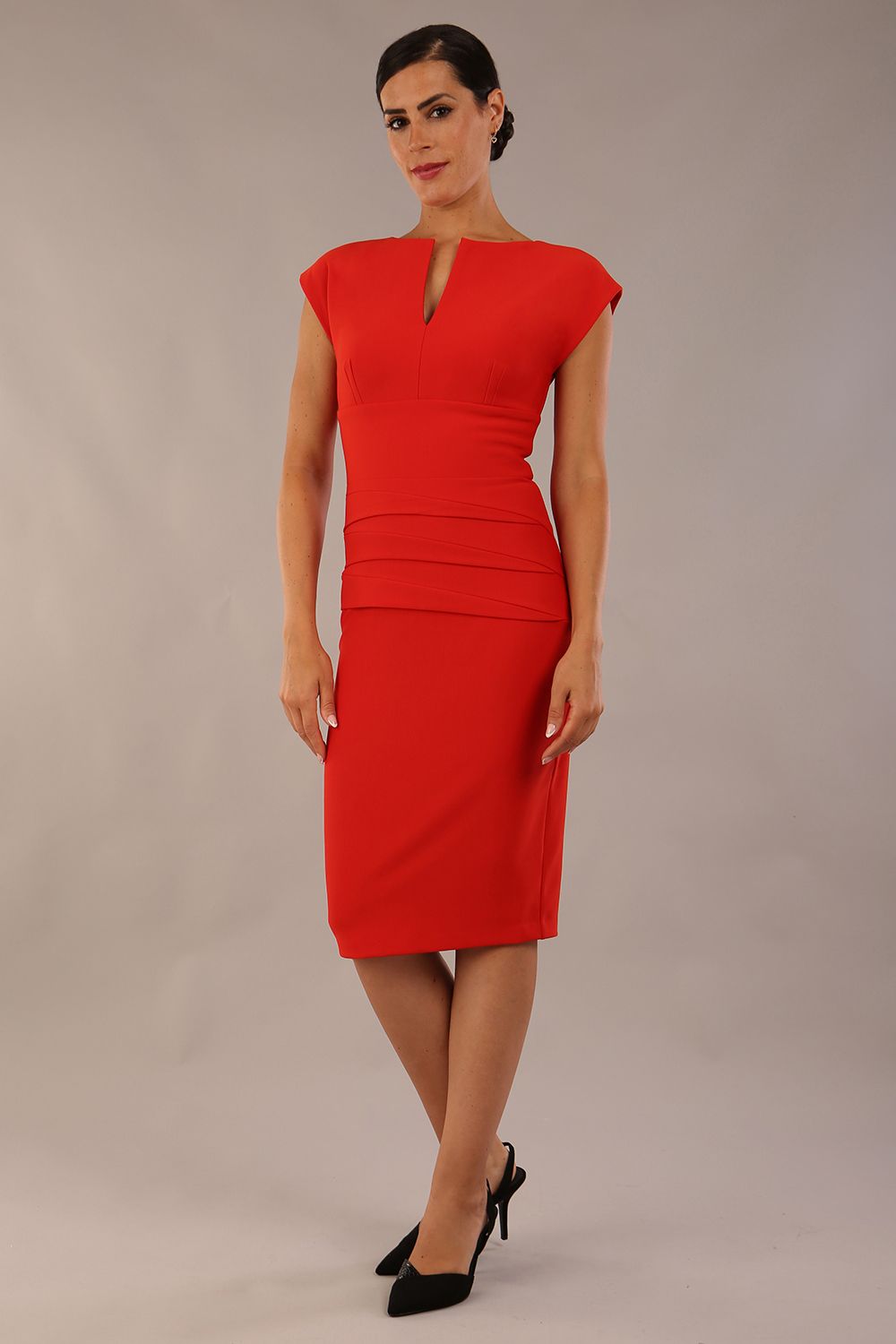 model wearing diva catwalk daphne sleeveless burn orange pencil dress with rounded neckline with split in the middle front 