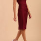 model wearing diva catwalk daphne sleeveless magenta haze pencil dress with rounded neckline with split in the middle in blissful burgundy side