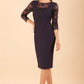 Brunette Model is wearing seed couture lace pencil dress by diva catwalk in black front