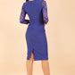 Brunette Model is wearing seed couture lace pencil dress by diva catwalk in monaco blue back