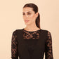 Brunette Model is wearing seed couture lace pencil dress by diva catwalk in black front close up