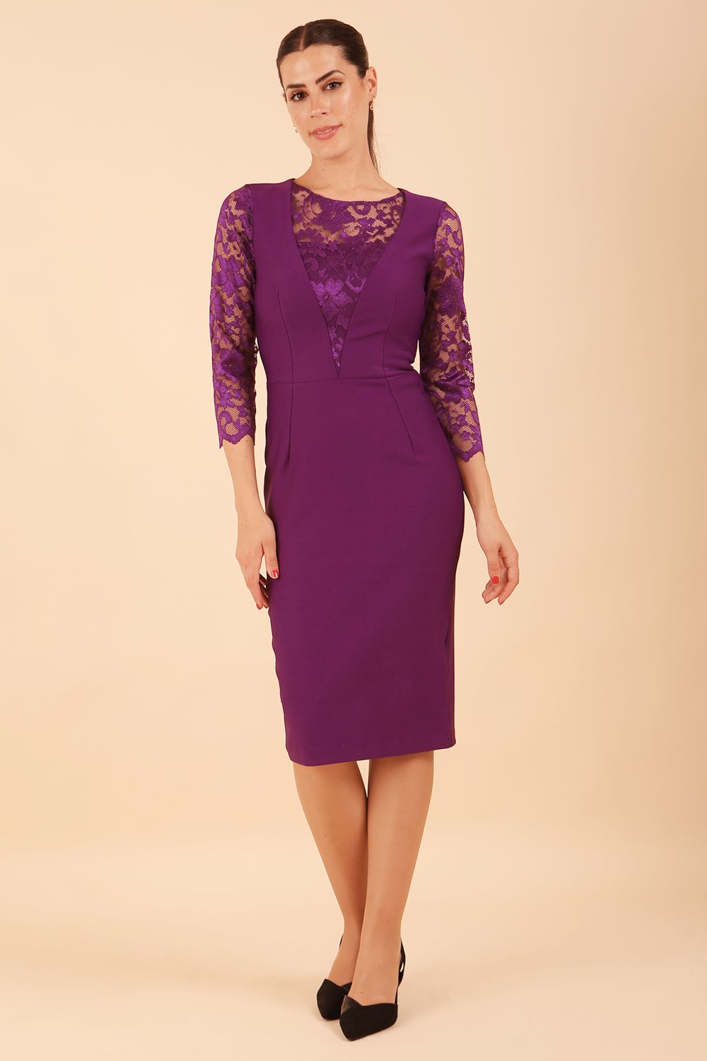 Brunette Model is wearing seed couture lace pencil dress by diva catwalk in imperial purple front