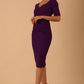model wearing diva catwalk couture wiltshire fitted pencil-skirt dress with short sleeves and open v-neckline and pleating across the tummy area in imperial purple colour front