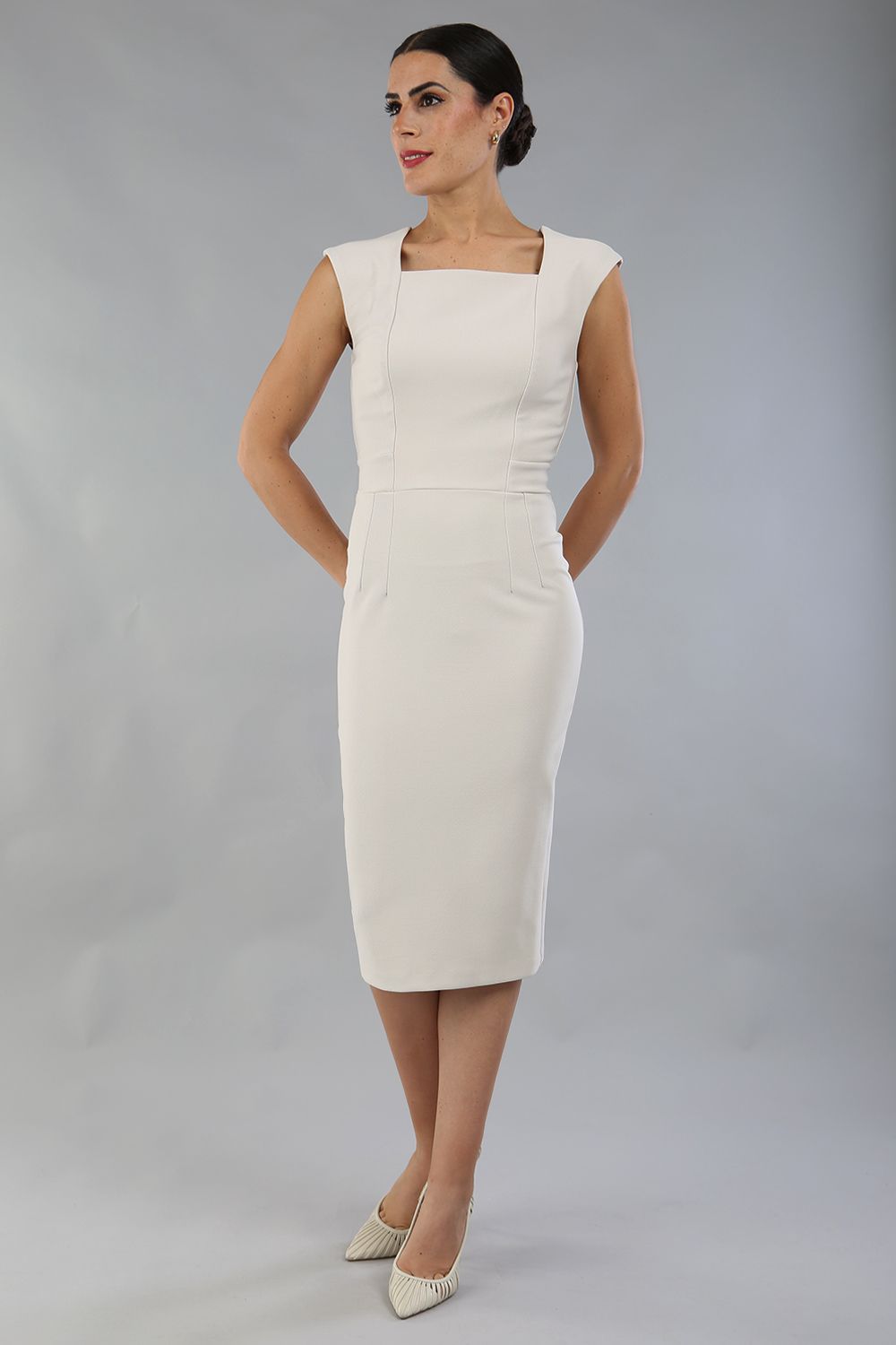 model is wearing diva catwalk seed cadiz pencil sleeveless dress in sandy cream front