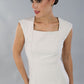 model is wearing diva catwalk seed cadiz pencil sleeveless dress in sandy cream front close up