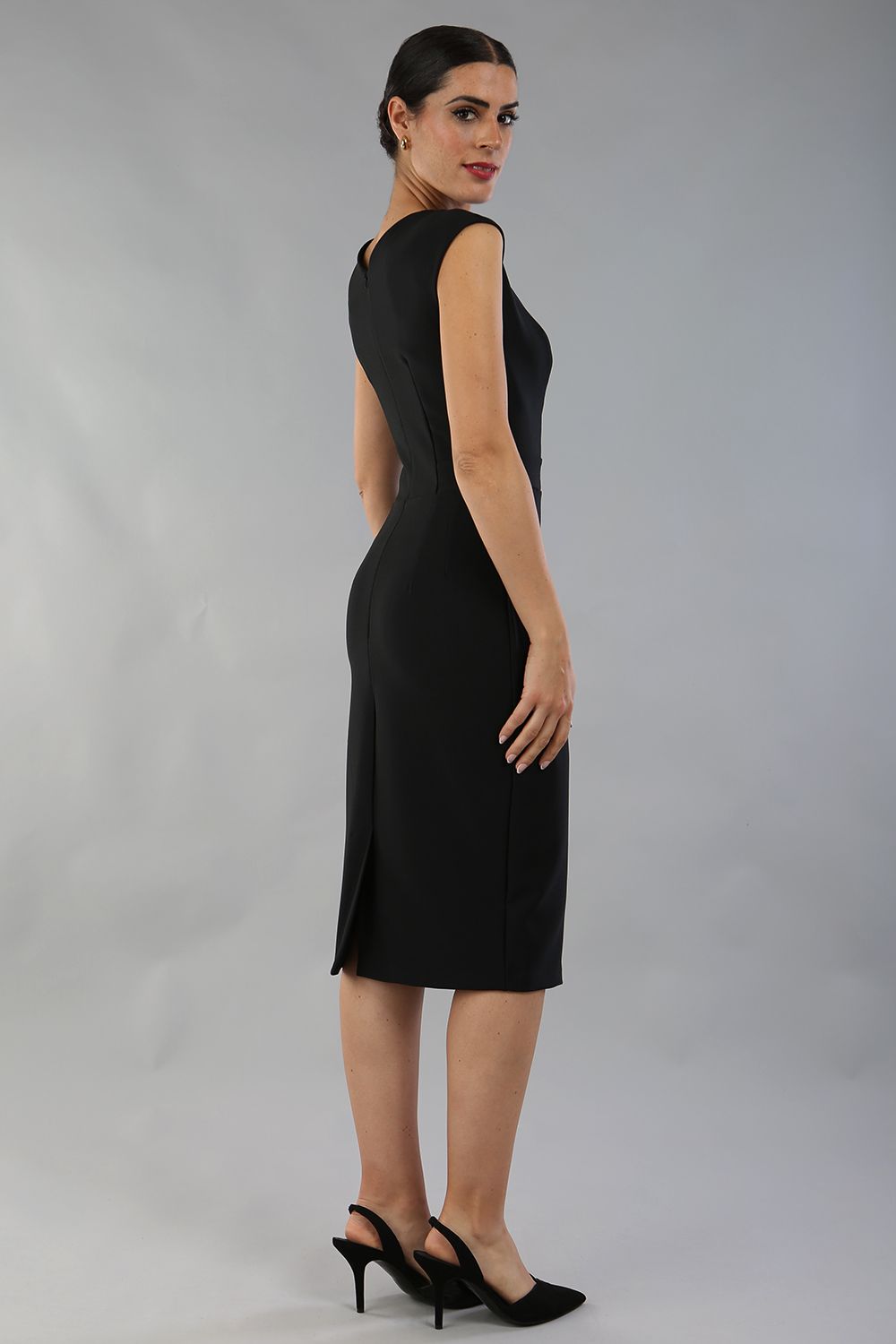 model is wearing diva catwalk seed cadiz pencil sleeveless dress in black back