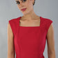 model is wearing diva catwalk seed cadiz pencil sleeveless dress in crimson pink front close up