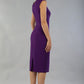 model is wearing diva catwalk seed cadiz pencil sleeveless dress in imperial purple back