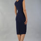 model is wearing diva catwalk seed cadiz pencil sleeveless dress in navy blue back