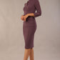 Model wearing the Diva Daphne ¾ Sleeved dress with pleat detail across the hips and ¾ sleeve length in mauve purple front side