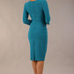 Model wearing the Diva Daphne ¾ Sleeved dress with pleat detail across the hips and ¾ sleeve length in mosaic blue back