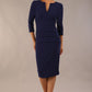 Model wearing the Diva Daphne ¾ Sleeved dress with pleat detail across the hips and ¾ sleeve length in navy front