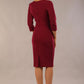 Model wearing the Diva Daphne ¾ Sleeved dress with pleat detail across the hips and ¾ sleeve length in blissful burgundy back