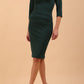 Model wearing the Diva Daphne ¾ Sleeved dress with pleat detail across the hips and ¾ sleeve length in forest green front
