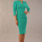 Model wearing the Diva Daphne 3/4 Sleeved dress with pleat detail across the hips and 3/4 sleeve length in Emerald Green side