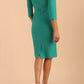 Model wearing the Diva Daphne 3/4 Sleeved dress with pleat detail across the hips and 3/4 sleeve length in Emerald Green back