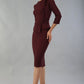 Brunette Model is wearing a three quarter sleeve couture seed pencil dress frill side detail by Diva Catwalk