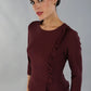 Brunette Model is wearing a three quarter sleeve couture seed pencil dress frill side detail by Diva Catwalk