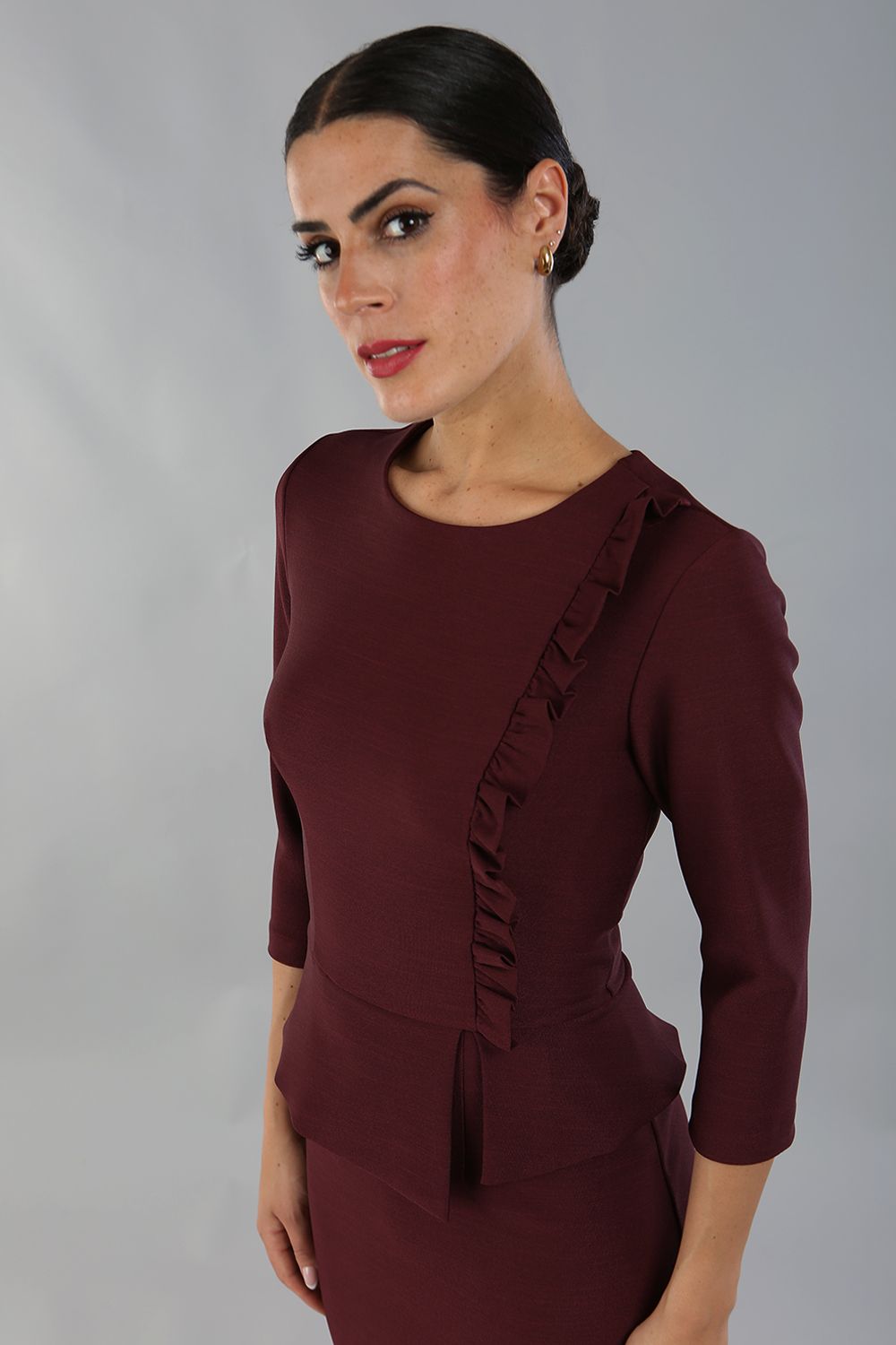 Brunette Model is wearing a three quarter sleeve couture seed pencil dress frill side detail by Diva Catwalk