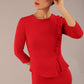 Brunette Model is wearing a three quarter sleeve couture seed pencil dress frill side detail by Diva Catwalk in salsa red