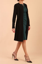 model wearing diva catwalk teal coat with long sleeves and a belt in Black side