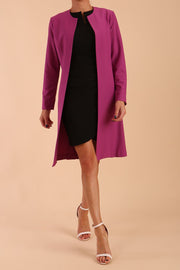 model wearing diva catwalk teal coat with long sleeves and a belt in Orchid Purple front