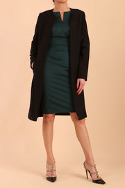 model wearing diva catwalk teal coat with long sleeves and a belt in Black front
