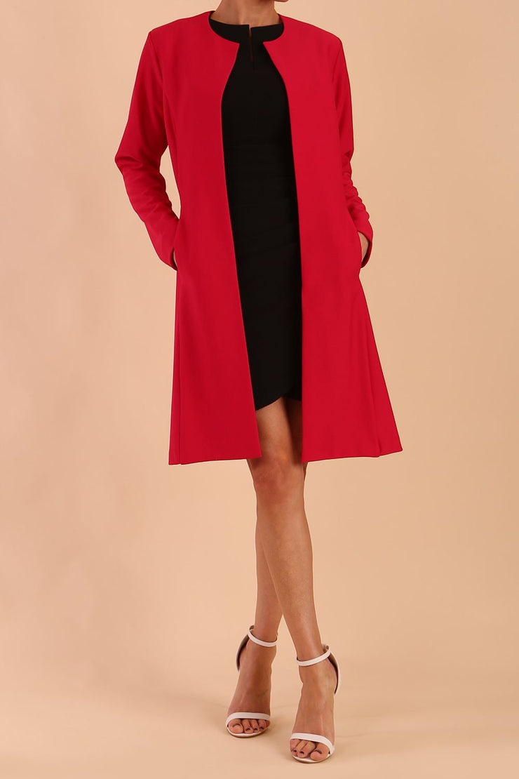 model wearing diva catwalk teal coat with long sleeves and a belt in Rose Red front