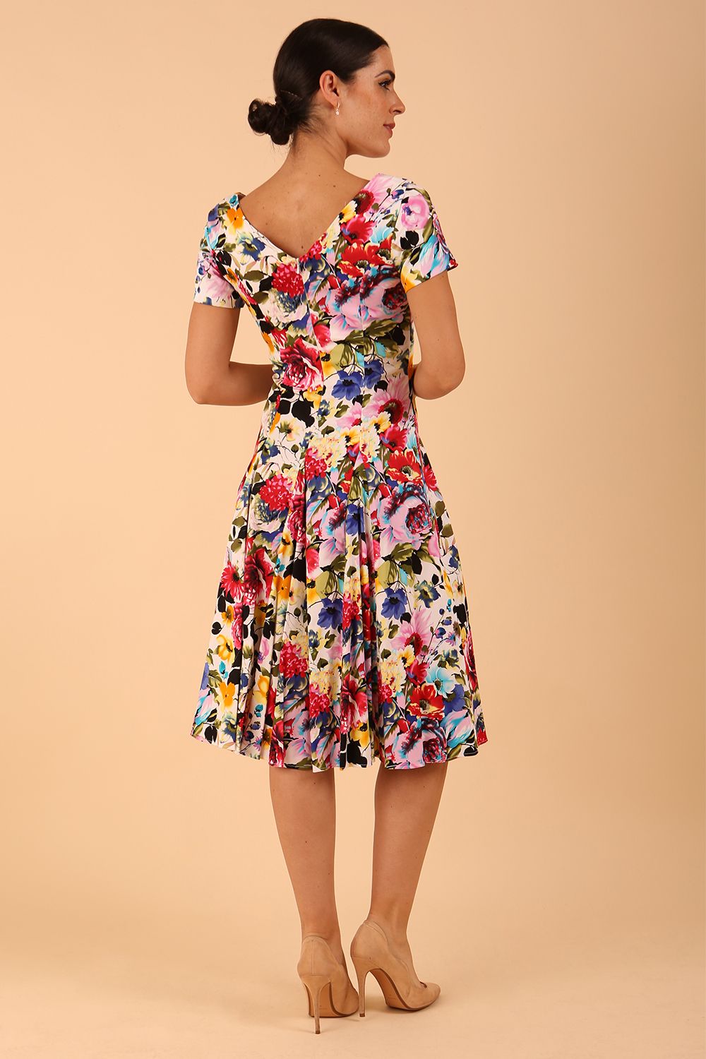Model wearing a diva catwalk Iris Print Dress short sleeve swing skirt in Fusion Print Colour back