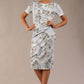 model wearing a  diva catwalk Katia pencil dress with a cascading layered skirt and stunning floral patterns with shor sleeves and knee length in botanical passion light blue print