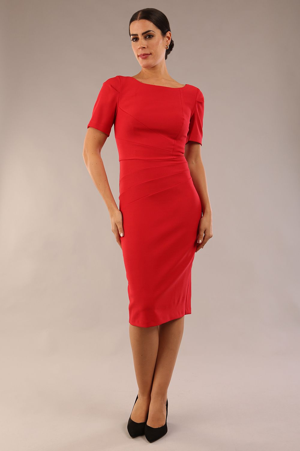 model is wearing diva catwalk seed charlotte pencil plain dress with short sleeve and pleated detail on the shoulder in salsa red colour front