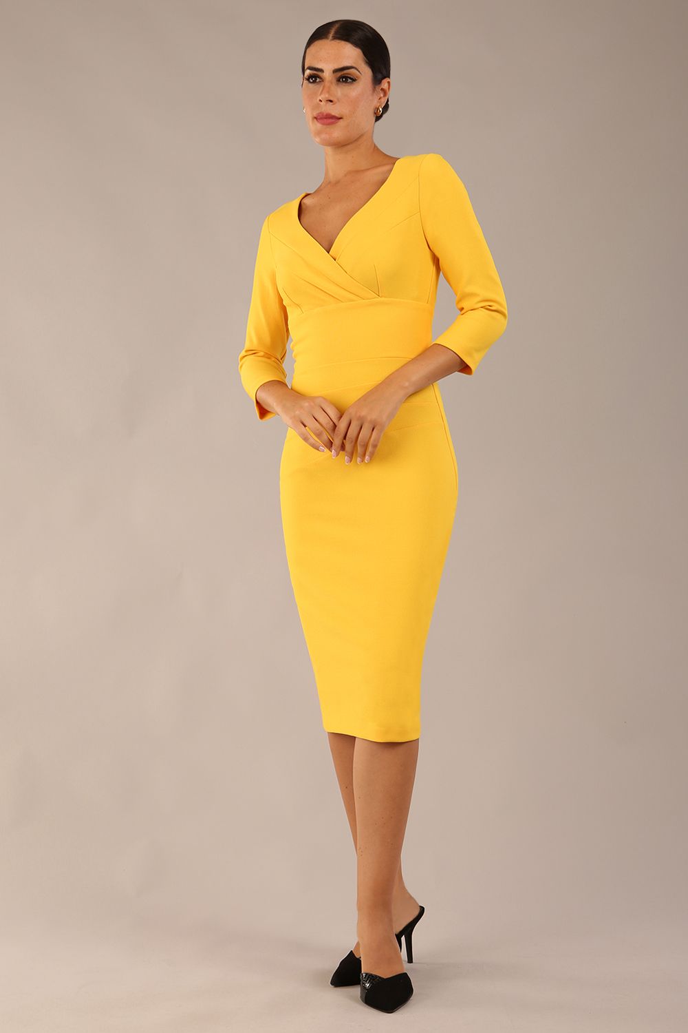 model wearing a diva catwalk Seed Barton Sleeved Pencil Dress 3/4 sleeves and v neckline and knee length with pleating details in daffodil yellow colour