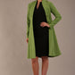 blonde model wearing diva catwalk couture fine raquella coat with buttons across the front and long sleeves with high neck and pockets in citrus green colour front (Citrus Green)