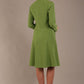 blonde model wearing diva catwalk couture fine raquella coat with buttons across the front and long sleeves with high neck and pockets in citrus green colour back (Citrus Green)