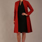 blonde model wearing diva catwalk couture fine raquella coat with buttons across the front and long sleeves with high neck and pockets in garnet red colour front (Garnet Red)