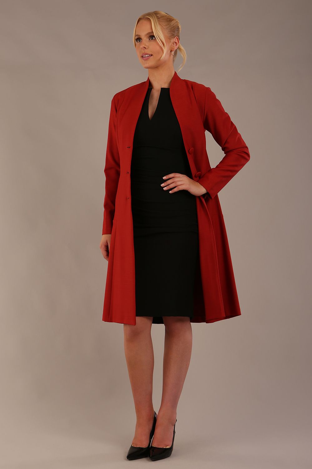 blonde model wearing diva catwalk couture fine raquella coat with buttons across the front and long sleeves with high neck and pockets in garnet red colour front (Garnet Red)