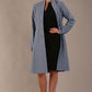 blonde model wearing diva catwalk couture fine raquella coat with buttons across the front and long sleeves with high neck and pockets in steel blue colour front (Steel Blue)