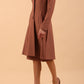  model wearing diva catwalk couture fine raquella coat with buttons across the front and long sleeves with high neck and pockets in acorn brown colour front