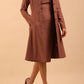  model wearing diva catwalk couture fine raquella coat with buttons across the front and long sleeves with high neck and pockets in acorn brown colour front
