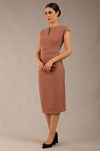 brunette model is wearing a diva catwalk seed Fitzrovia sleeveless pencil dress with round neckline and v-slit and knee length in acorn brown colour front image