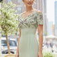 Woman wearing a light green dress with a floral pattern in an outdoor (Deco Green Fern)