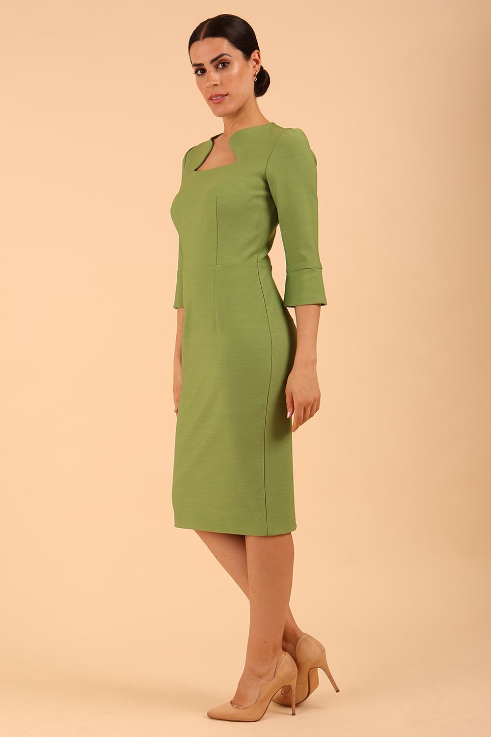 Brunette model is wearing couture stretch seed pencil bell 3/4 sleeve pencil dress by diva catwalk in Citrus Green front image