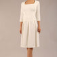 brunette model wearing a diva catwalk malinda swing dress with 3/4 sleeves and knee length and wide waistband in ripple crepe fabric in ivory cream colour front image