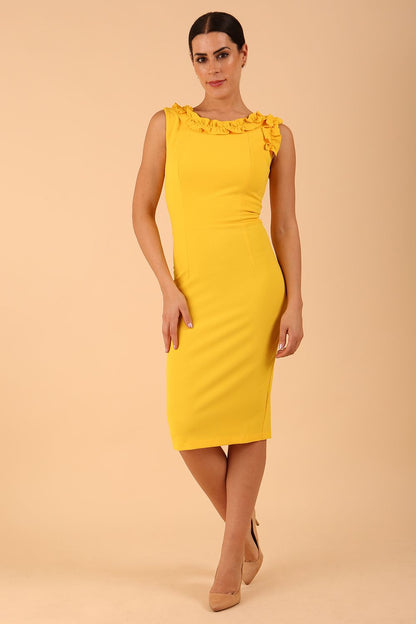 brunette model is wearing diva catwalk odessa pencil sleeveless dress with frill detail on rounded neckline in freesia yellow front