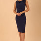 brunette model is wearing diva catwalk odessa pencil sleeveless dress with frill detail on rounded neckline in Navy Blue front
