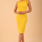 brunette model is wearing diva catwalk odessa pencil sleeveless dress with frill detail on rounded neckline in freesia yellow front