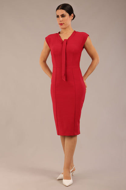 brunette model wearing a diva catwalk seed lucca tie detail cap sleeves pencil dress in crimson pink colour front image