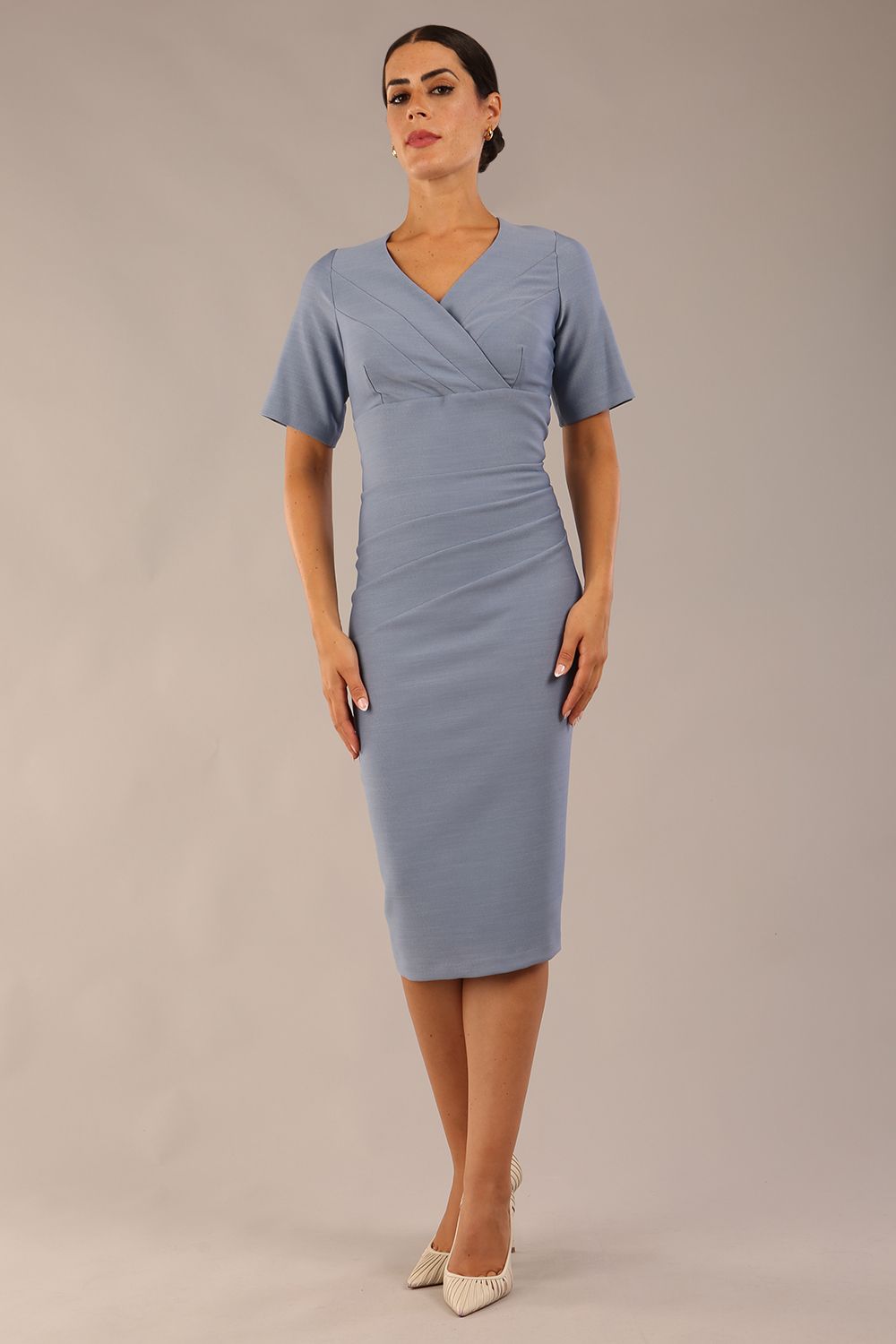 model is wearing diva catwalk seed barton short sleeve pencil dress with v-neck in steel blue front 